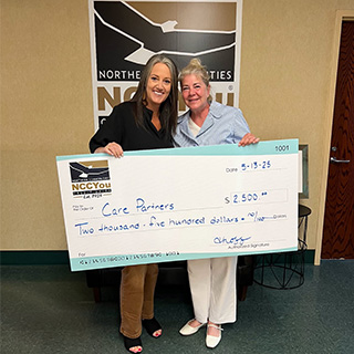 NCCYou President Trina Hoff provides donation check to Care Partners