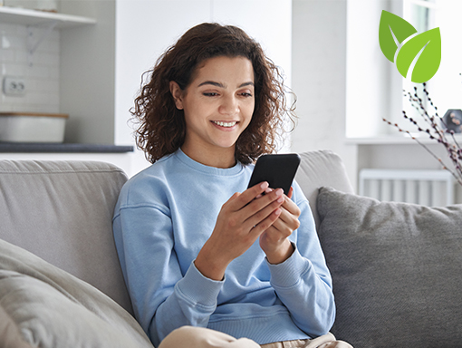 Go Green with Estatements Lady on couch using her cell phone