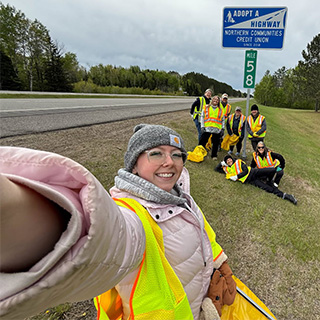 NCCYou Employees pose as Highway marker