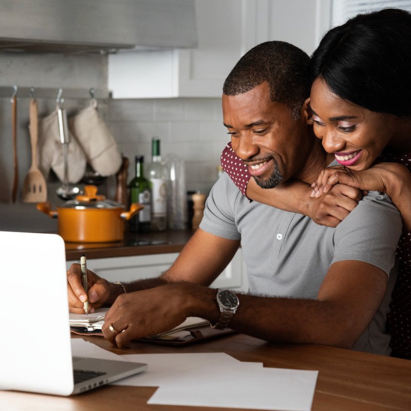 Couple on laptop setting up budget