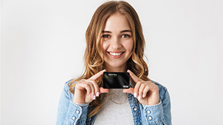 A young woman holding a visa credit card
