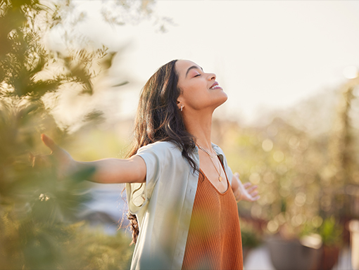 A young lady with arms out looking relaxed