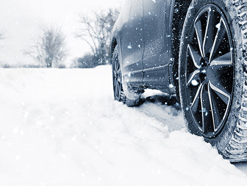 Vehicle driving on snowy road.